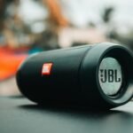 Focused shot of a black JBL portable speaker on a surface, ideal for technology concepts.